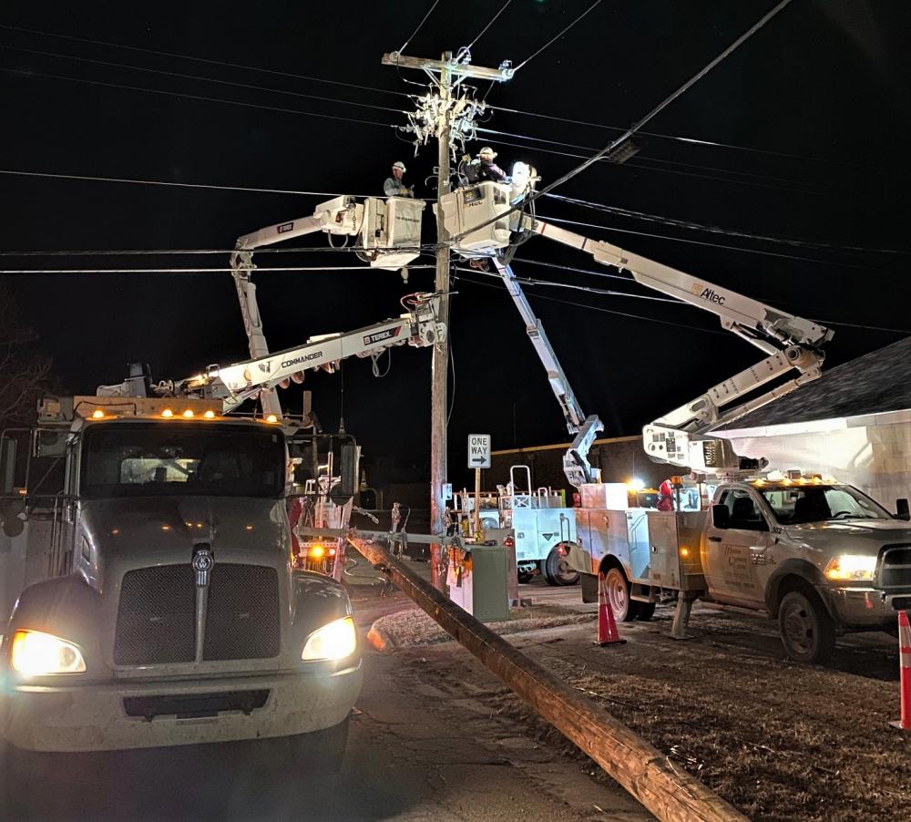 picture of linemen working at night.